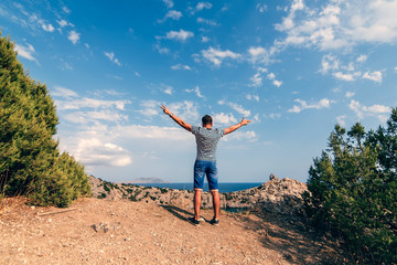 Fototapeta premium male traveler with arms raised to the sky