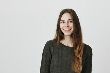 Casual portrait of young attractive european girl smiling happily with sincere look, isolated over...