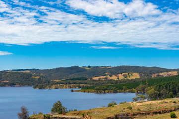 Fototapeta na wymiar Australian landscape of lake, dam, and eucalyptus on hills