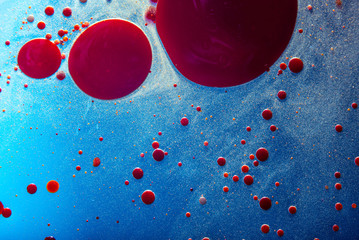 Red bubbles of blood cells on blue background closeup. Abstraction of medicine. Concept of micro processes and diseases