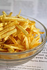 Delicious Yellow Potato Fries Snack Food on a Plate, Close Up