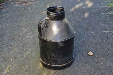 A colorful black milk can