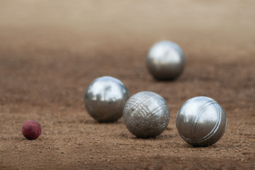 Metallic petanque four balls and a small wood jack