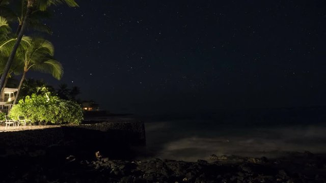 Night to day time lapse of the Southern Cross over an island beach