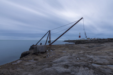 Fototapeta na wymiar The lighthouse and lifting crane at Portland Bill in Dorset.