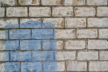 old white brick walls with blue spot