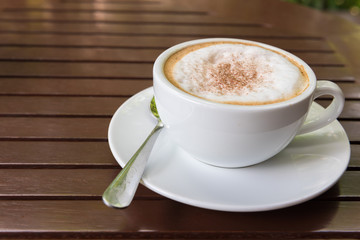 Cappuccino cup on wooden table