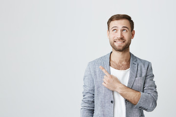 Check this out! Cropped studio shot of attractive good-looking excited man with subble dressed in...