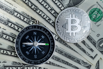 Compass and Bitcoin Crypto currency on money banknotes as direction of Crypto future trading
