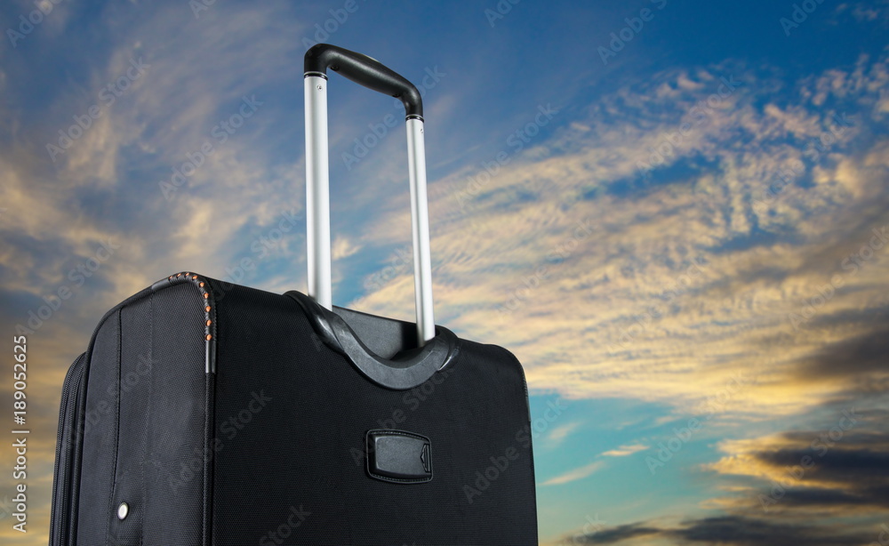 Wall mural suitcase with the sky. travel concept