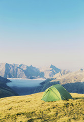 Tent standing on a mountain top.