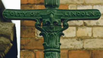 Close up of Old Lincoln Lamp Post, Blurred Wall in Background, Shallow Depth of Field Horizontal Photography - 189053605