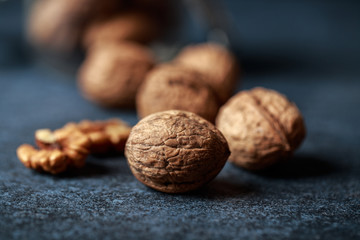 Walnuts. Walnut kernels and whole walnuts on rustic table.