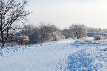 Obraz na płótnie Canvas Snowy road after snowfall. Winter rural landscape