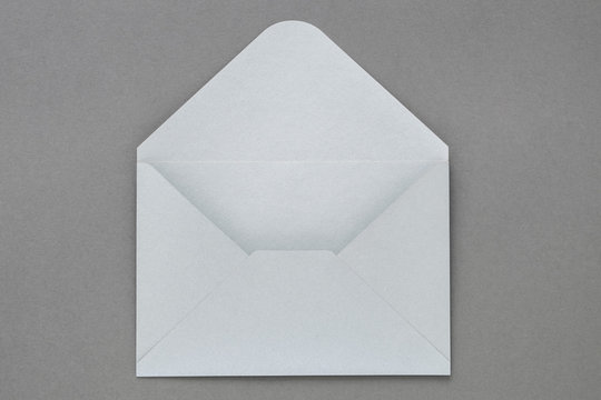 Open gray envelope on dark gray background.