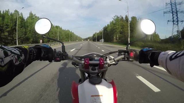 Saint-Petersburg, Leningradskaya obl., Russia - 07/15/2017: Driving a motorbike on an asphalt road at countryside