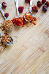 Various hot spices on a wooden background