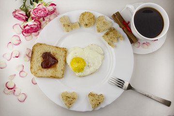 Fototapeta na wymiar Breakfast for lovers, scrambled eggs,coffee, roses