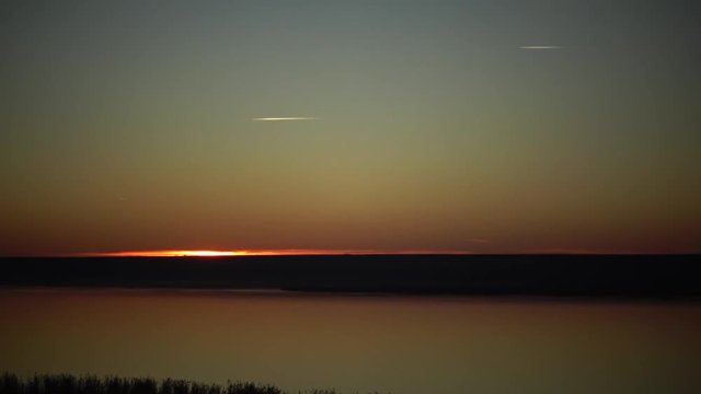 Sunset over the lake, jets in the sky