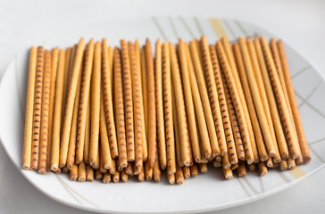 biscuits in the form of long thin straws of yellow and brown color