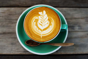 Cappuccino coffee in a green cup