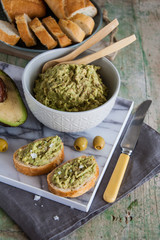 Snack appetizer with avocado (sandwich with guacamole)