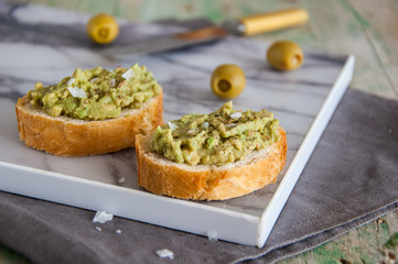 Snack appetizer with avocado (sandwich with guacamole)
