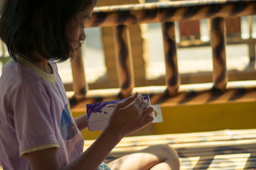 asian girl painting on a box