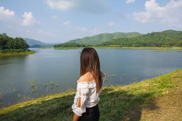 lady white shirt stand and look out lake view