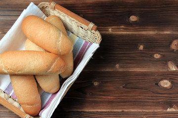Fresh bread on wooden table. Top view with space for your text