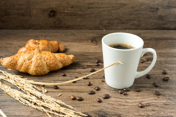 coffee break, White coffee cup, croissants on wood table background, selective focus. Breakfast concept