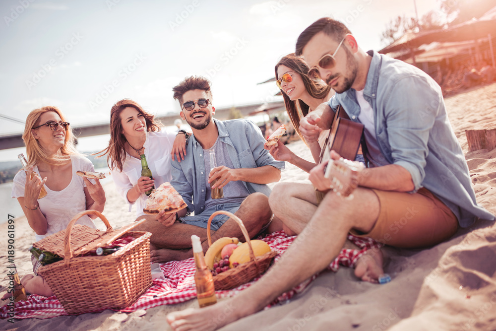 Canvas Prints Group of friends having a party on the beach.