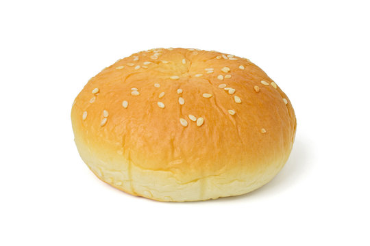 Burger bun with white sesame seeds isolated on a white with clipping path