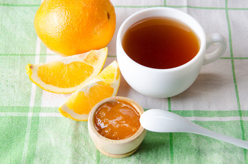 Cup of tea served with orange jam