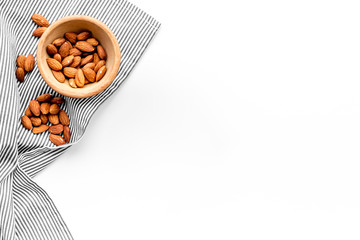 Nuts. Almond in bowl on white background top view copy space
