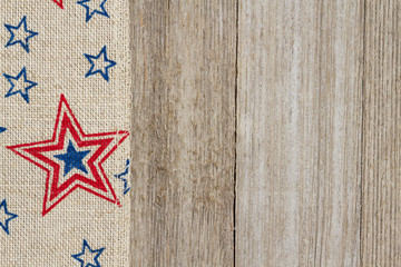 USA red and blue stars burlap ribbon on weathered wood background