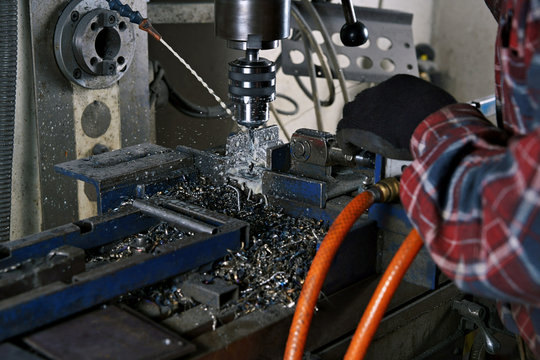 Drilling, a man working on a liquid-cooled drill.