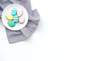 Sweets for celebrate Easter. Gingerbread in shape of easter eggs. White background top view copy space