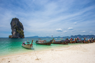 Railay beach with colorful long tail boats in Krabi, Thailand in beautiful sky day