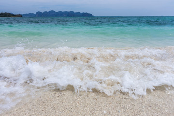 Crashing wave and white sand beach at Railay beach,  Krabi, Thailand