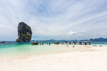 Fototapeta premium Railay beach with colorful long tail boats in Krabi, Thailand in beautiful sky day