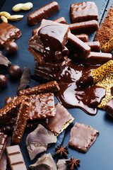 A variety of chocolate products on a dark background.
