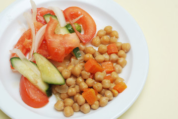 Healthy Food Concept. Closeup of Vegetable Salad on white Plate. Tomatoes and Cucumber. Top View with Copy Space.