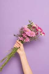 Woman's hand with a flowers bouquet
