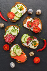 Homemade bruschetta. Mini sandwiches. Traditional spanish tapas on dark table. Brushetta set.