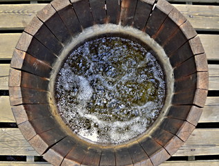 Wooden water well with bubbling water, national nature reserve Soos, Czechia