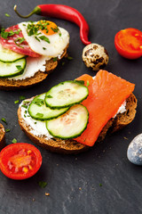 Homemade bruschetta. Mini sandwiches. Traditional spanish tapas on dark table. Brushetta set.