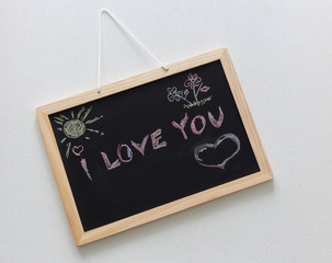 Written chalk on a school blaclboard, confession of love " I Love You " 