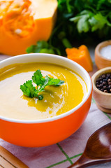 Pumpkin soup served on the table in bowl