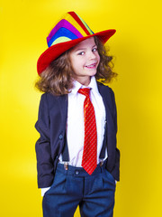Portrait of a smiling little boy in a big American hat and shirt. Happy child.